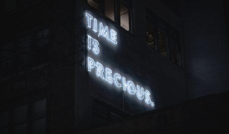 neon sign saying time is precious